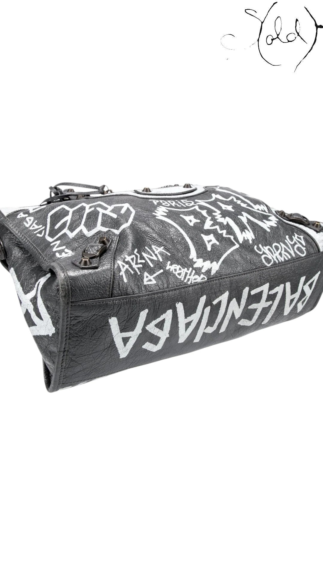 Sold Attire black agneau lambskin Balenciaga Graffiti City bag with white hand-painted graffiti and classic hardware.