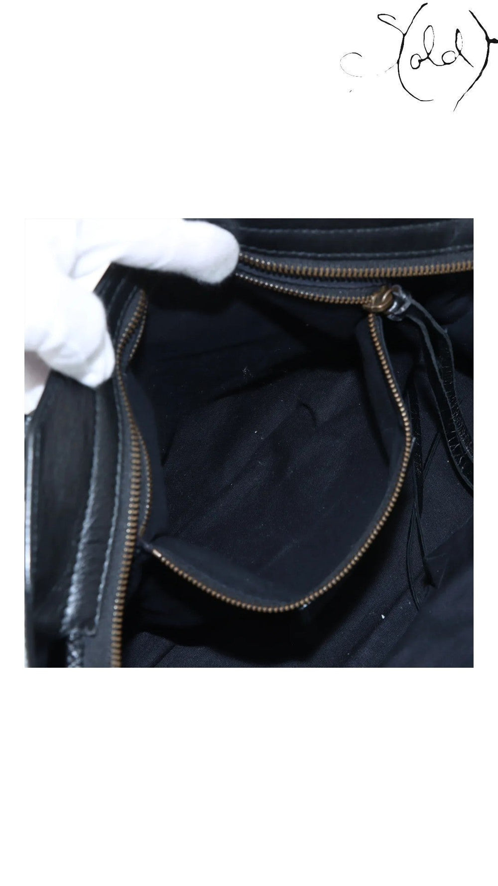 Sold Attire black agneau lambskin Balenciaga Graffiti City bag interior with zip pocket and black cotton lining.