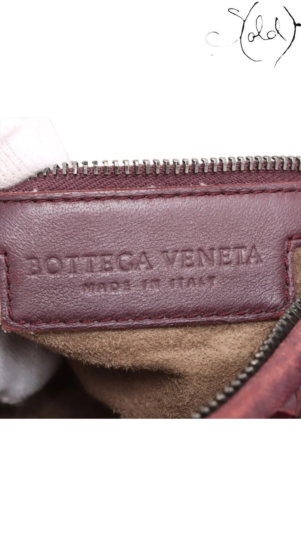 Sold Attire burgundy Bottega Veneta interior leather stamp and Made in Italy label inside a suede hobo bag