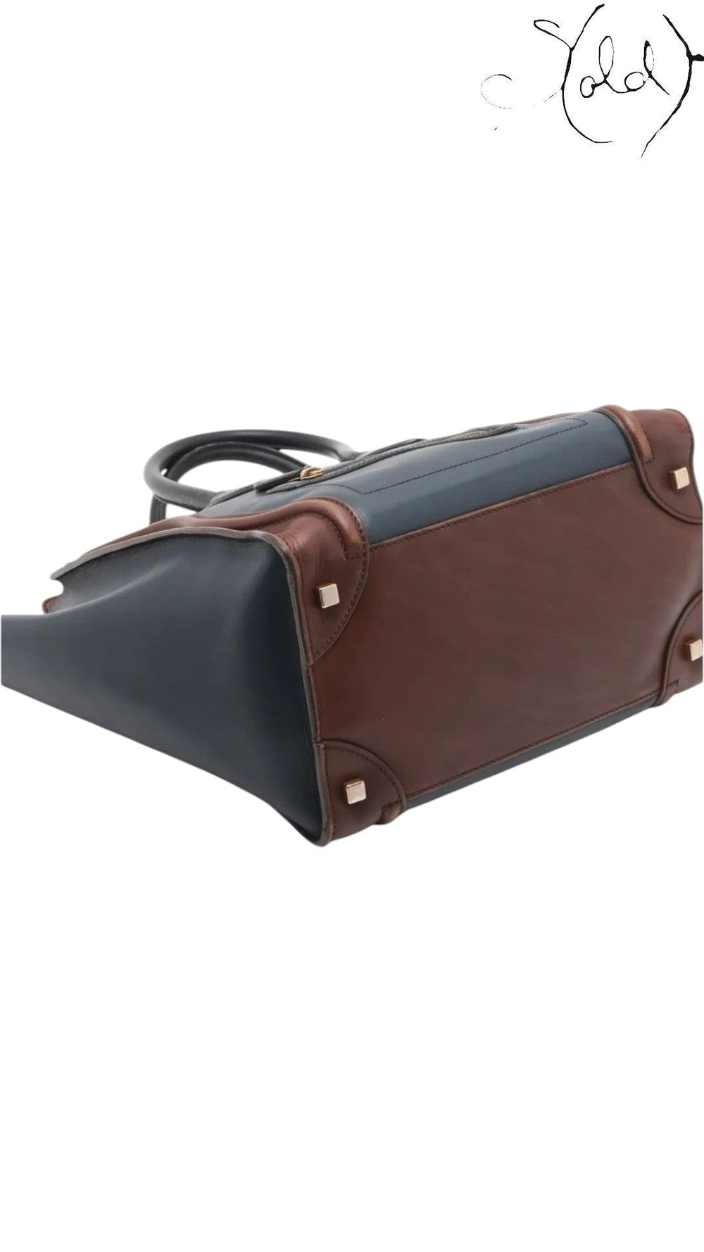 Sold Attire pre-owned Celine Luggage Mini Shopper in navy and brown leather, showing the base and protective feet.