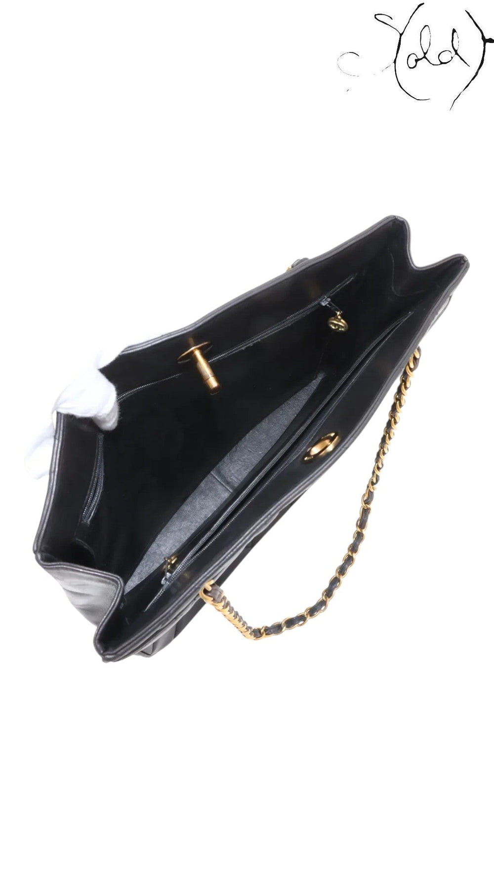 Sold Attire black quilted lambskin matelasse chain tote with gold-tone hardware and interior pockets.