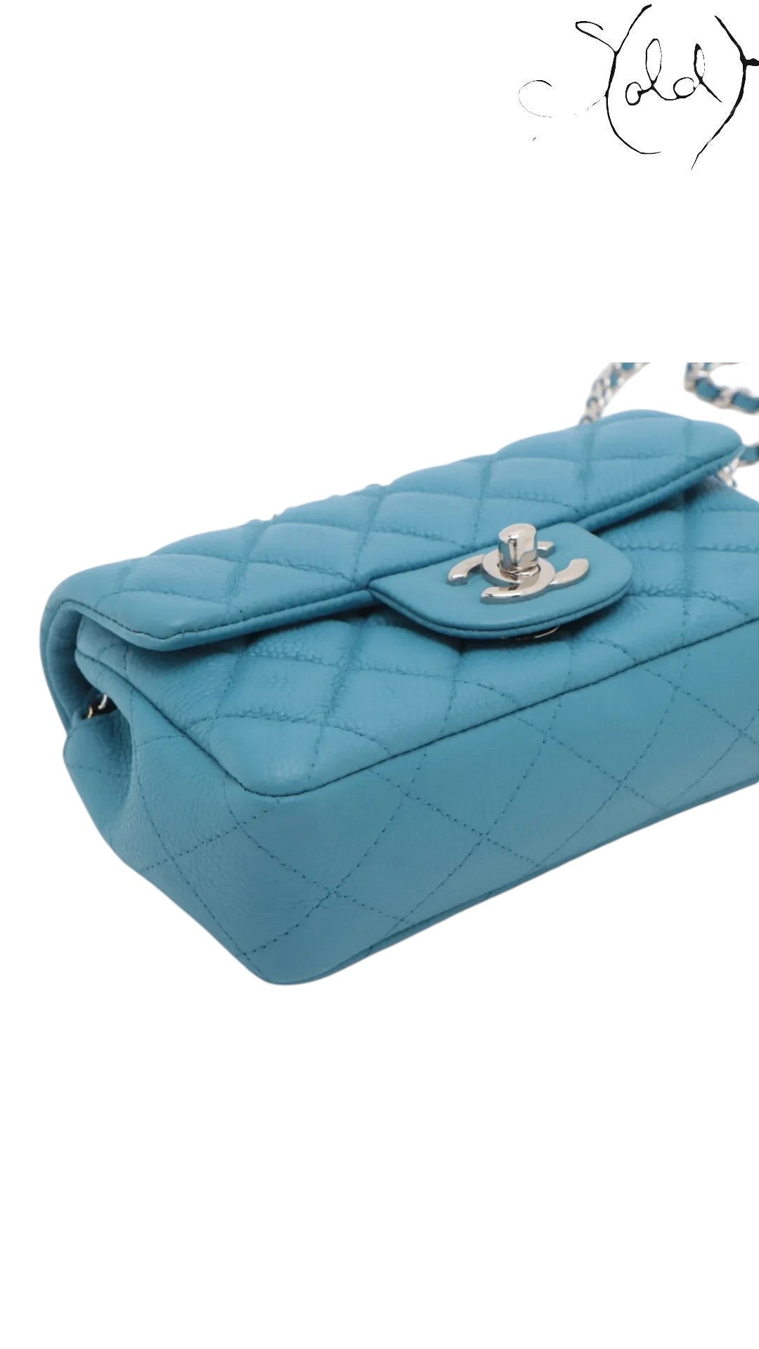 Sold Attire blue quilted caviar leather Chanel Extra Mini Classic Flap bag with silver-tone hardware and chain strap.