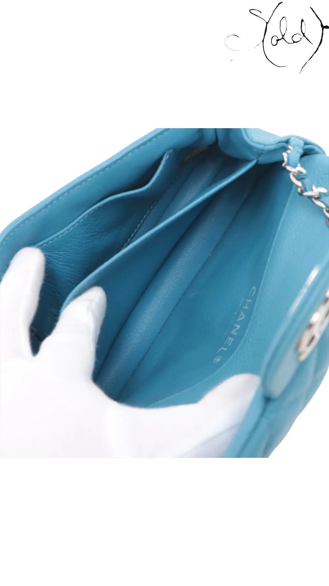 Sold Attire blue quilted caviar leather Chanel Extra Mini Classic Flap bag interior with card slots and silver-tone hardware.