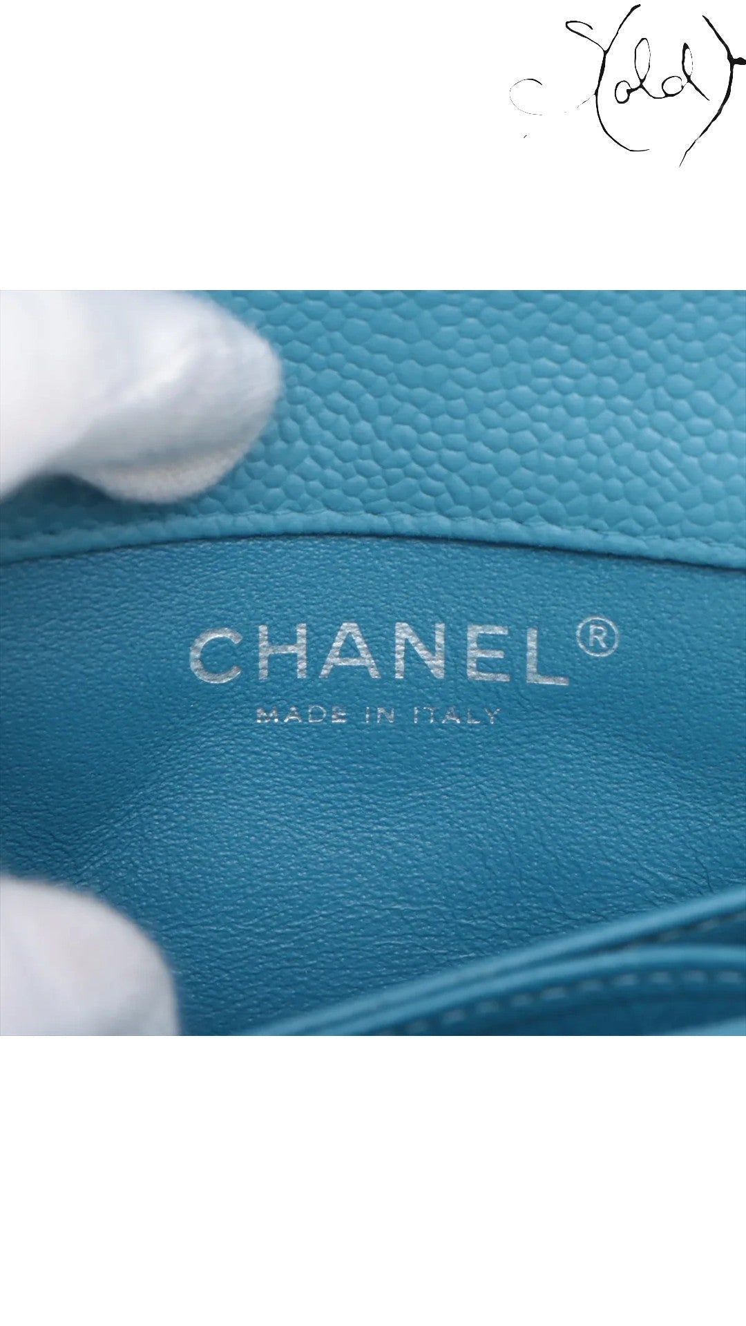 Sold Attire blue quilted caviar leather Chanel Extra Mini Classic Flap bag interior with silver-tone logo and Made in Italy stamp.
