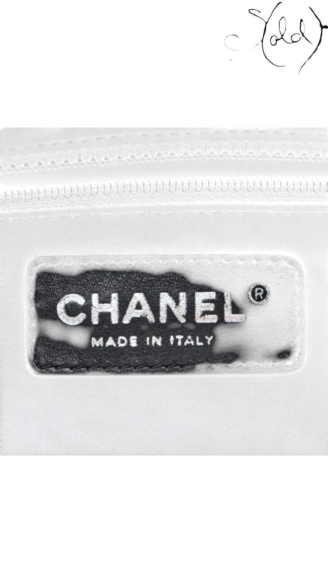 Sold Attire black Chanel Paris-Biarritz PM tote bag interior label with silver Chanel logo and Made in Italy text.