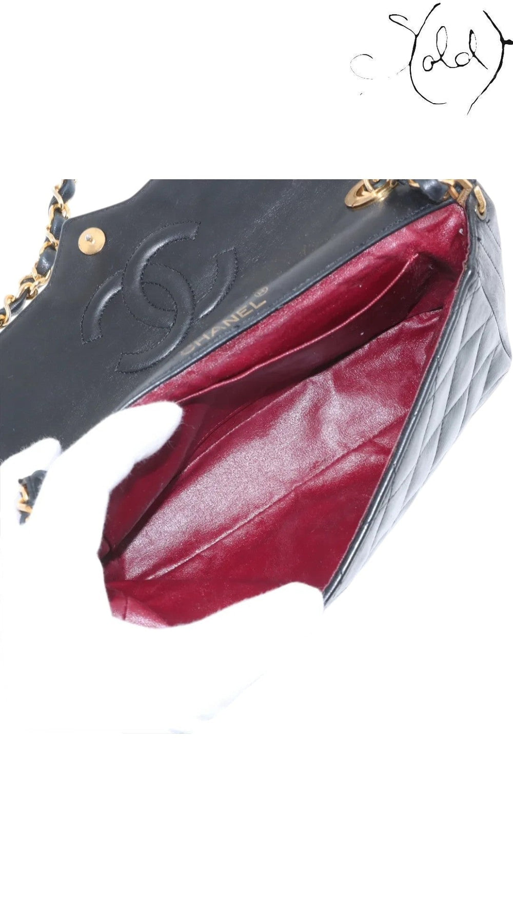 Sold Attire vintage Chanel single flap bag in black quilted lambskin with a burgundy leather interior.