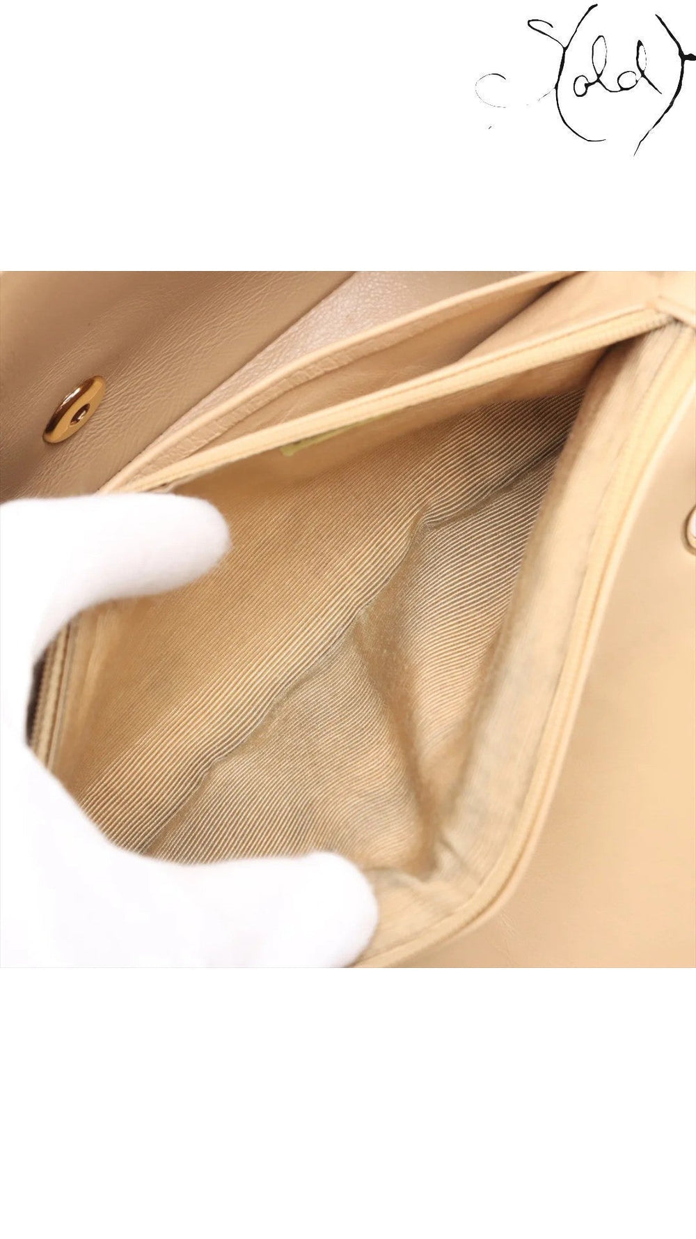 Sold Attire beige lambskin Chanel Diana medium bag interior with gold hardware clasp and striped lining.