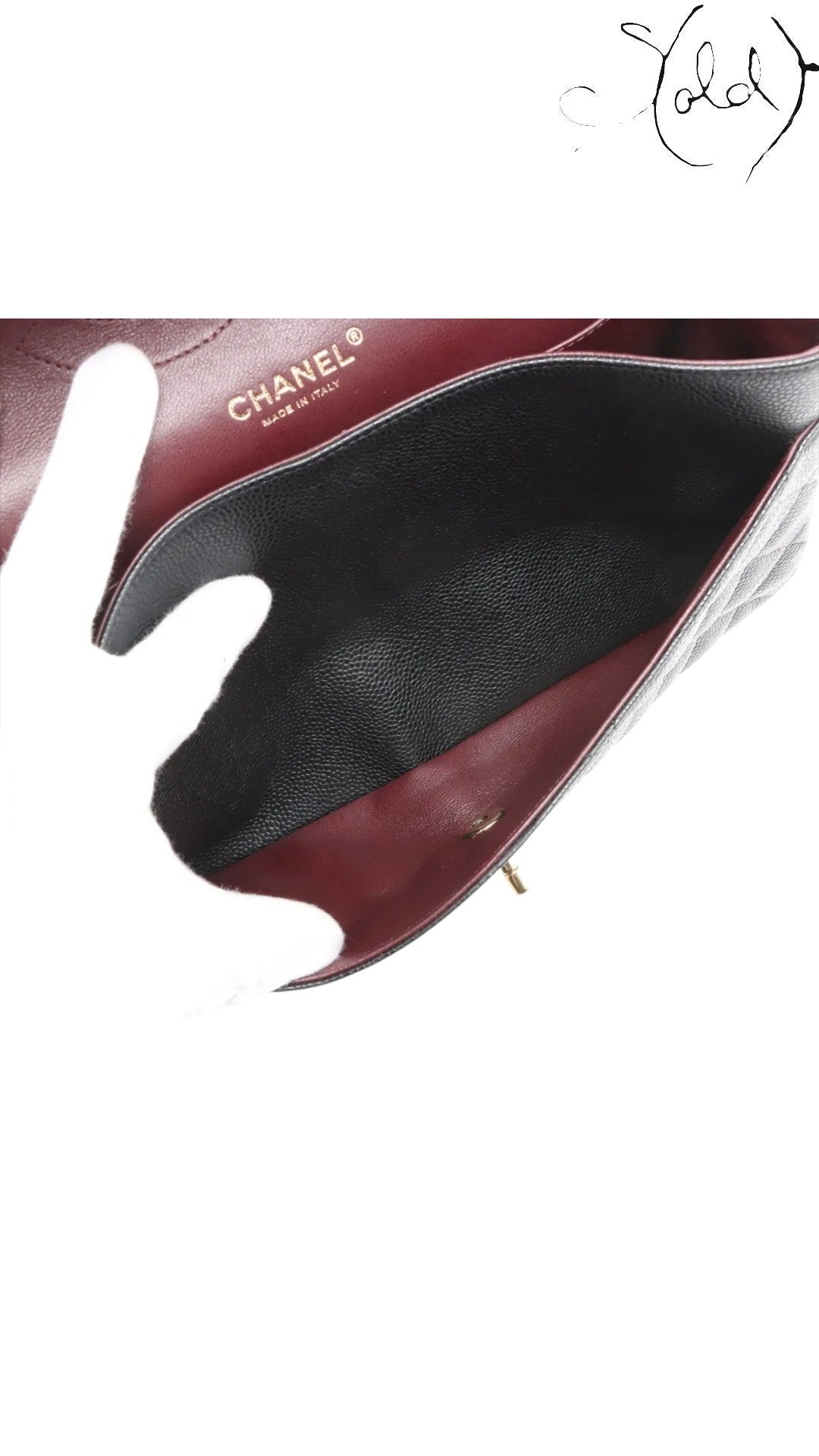 Sold Attire black caviar leather Chanel Jumbo Classic Double Flap bag with gold hardware and burgundy lining.