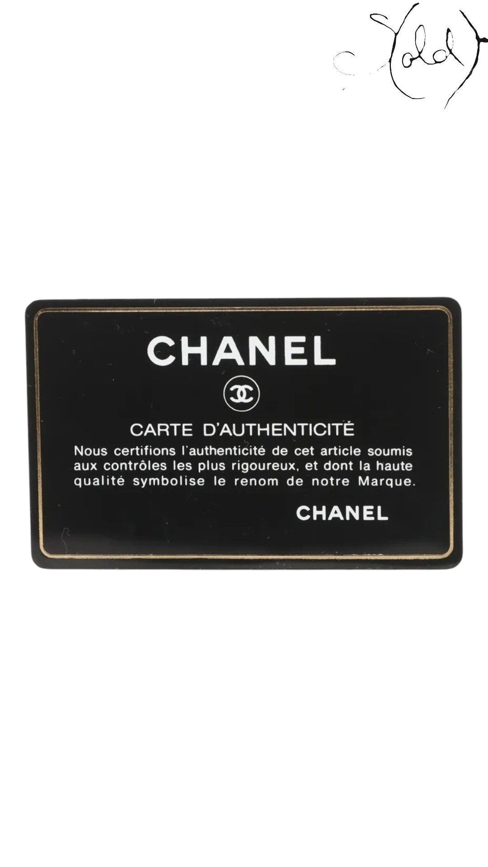 Sold Attire Chanel authenticity card, black with gold trim and text. Features Chanel logo and "Carte d'Authenticite" inscription.