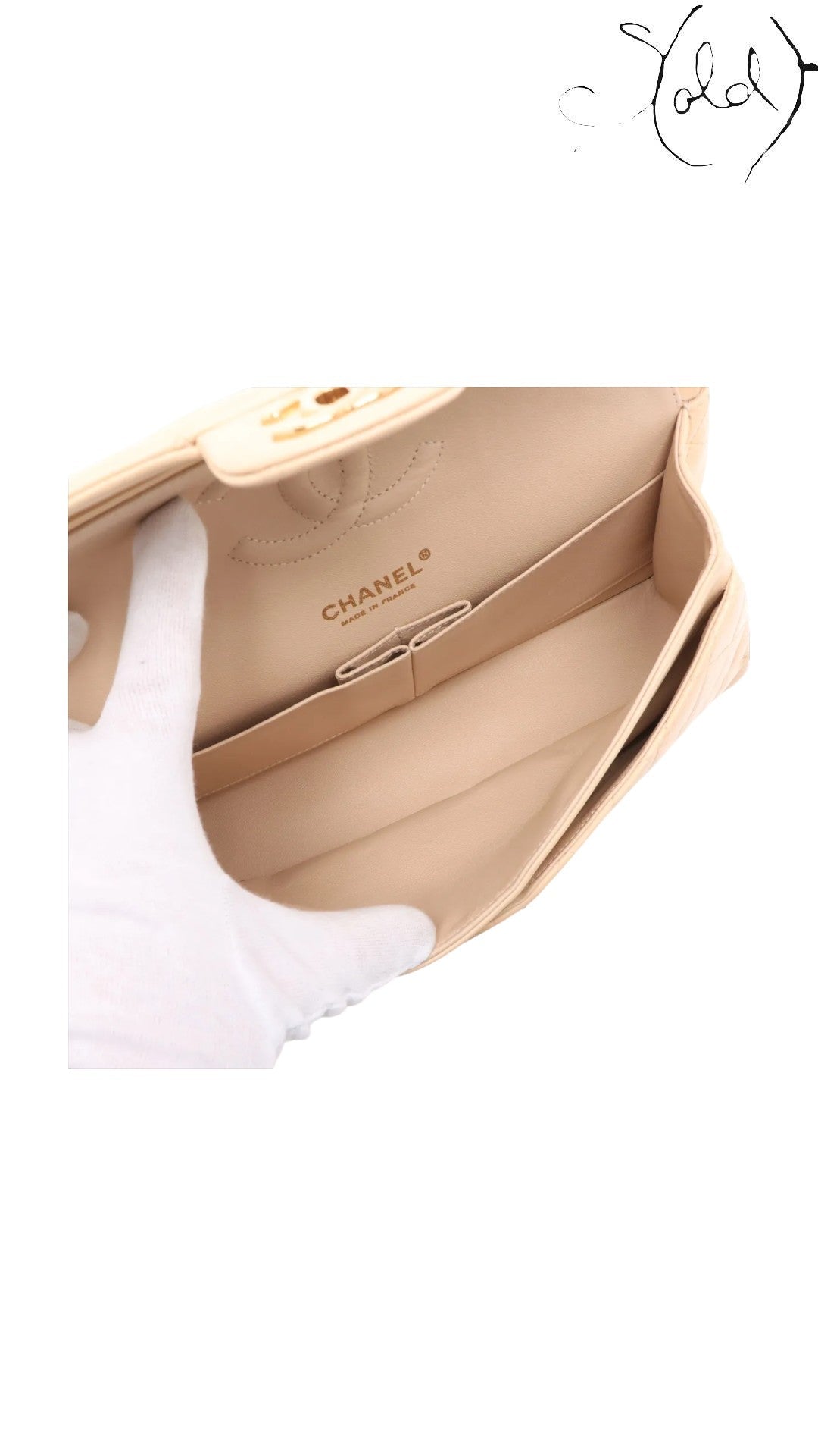 Sold Attire beige lambskin Chanel Medium Classic Double Flap bag interior with gold hardware and CC turnlock.