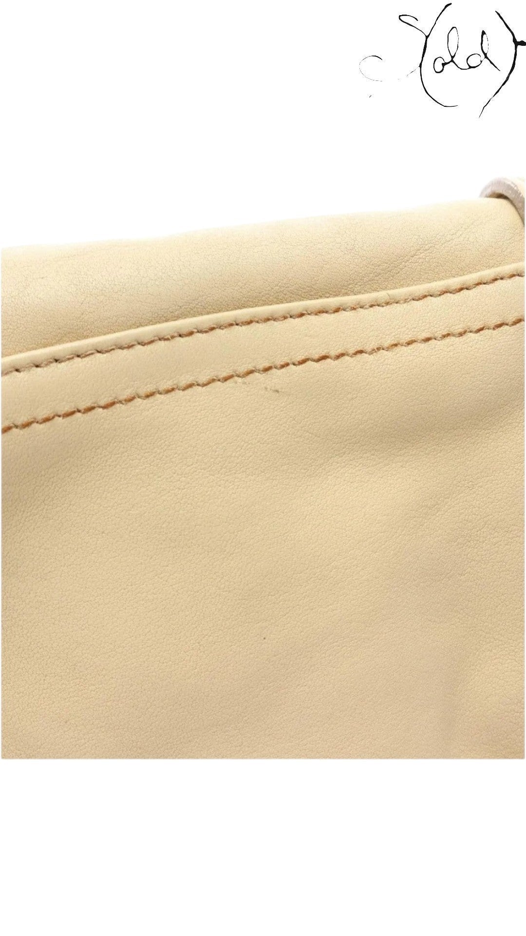 Sold Attire beige calf leather texture detail of a vintage Dior Gaucho shoulder bag with visible contrast stitching