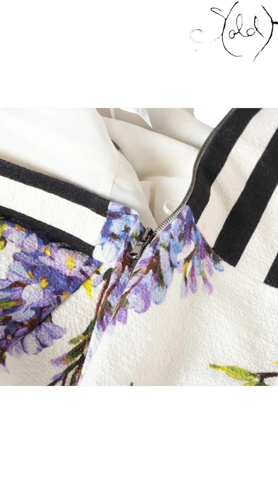 Sold Attire sleeveless white dress with a purple wisteria print and black and white striped bodice. Cotton-polyurethane blend.