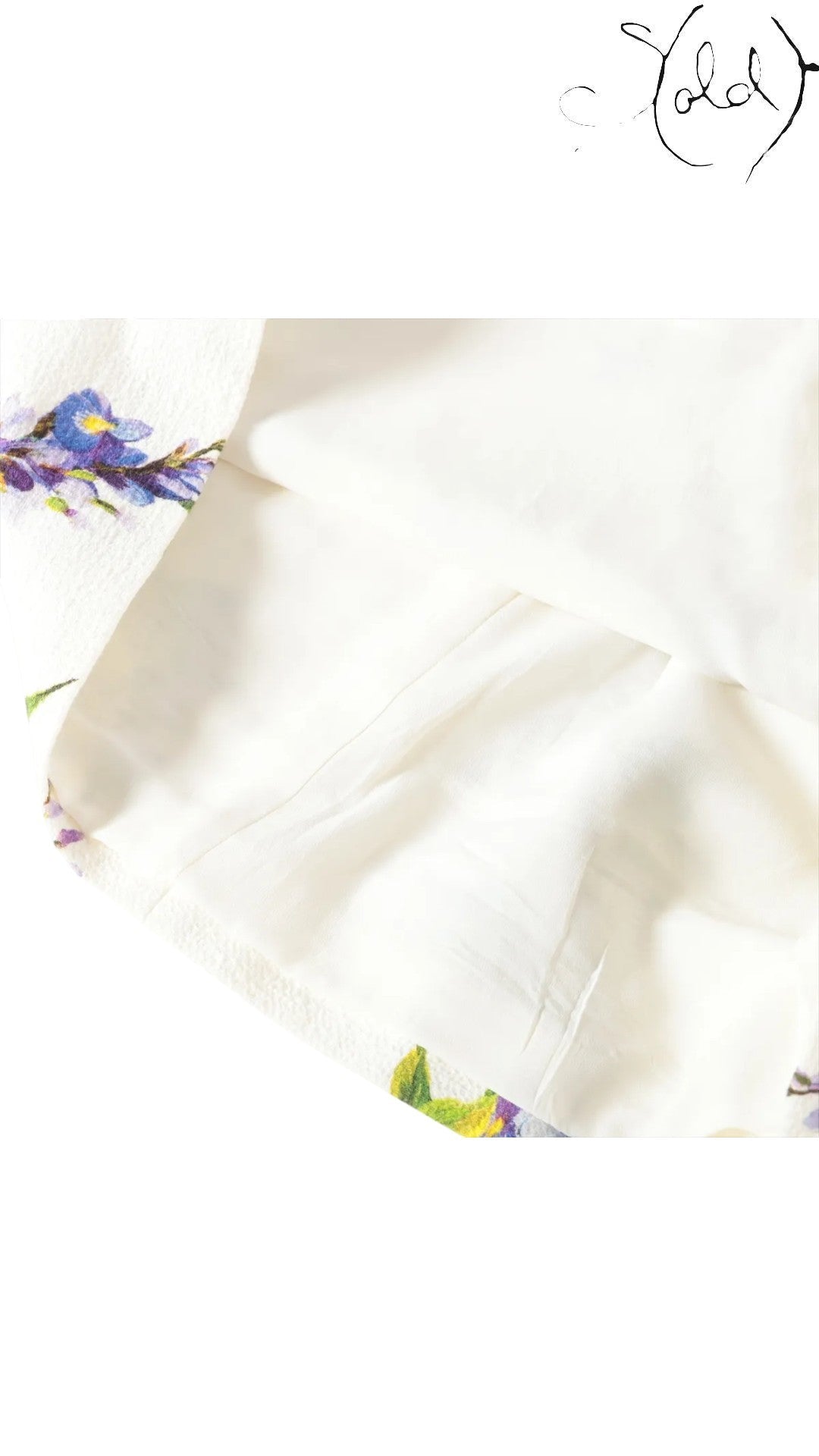 Sold Attire white sleeveless dress with a vibrant wisteria floral print and a black and white striped bodice. Cotton-polyurethane blend.