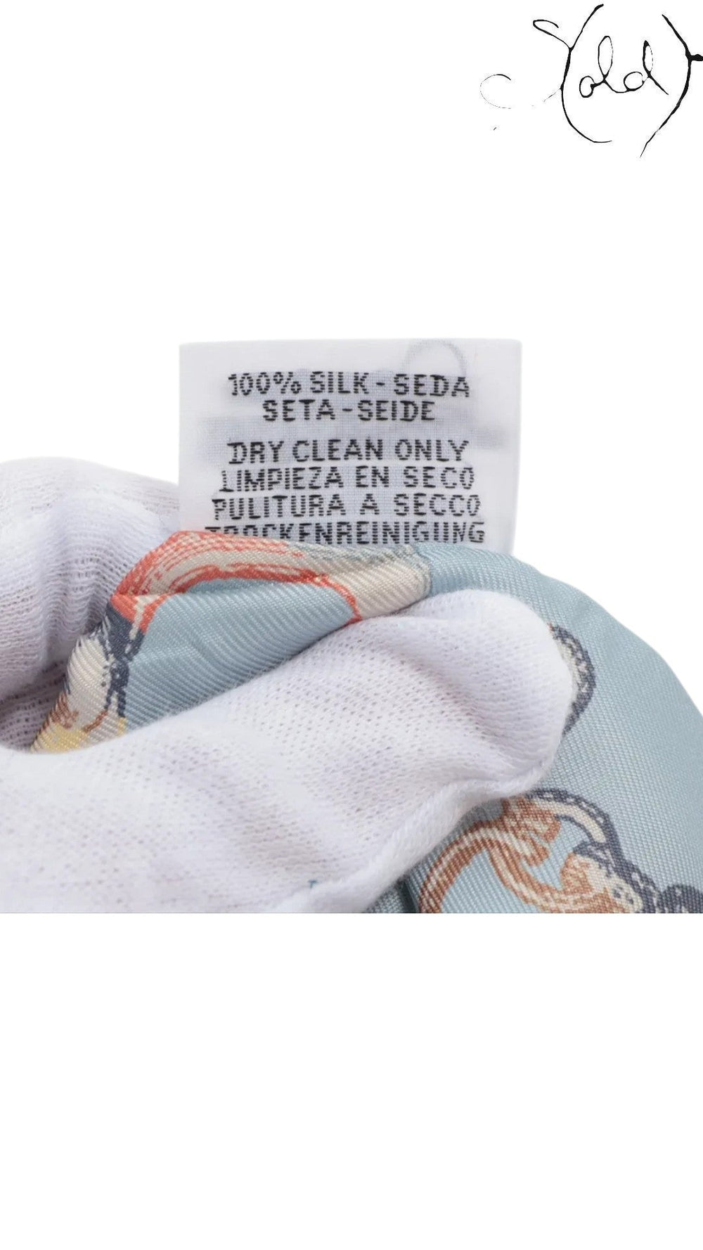 Sold Attire Hermes Twilly silk scarf care label showing 100% silk composition and dry clean only instructions