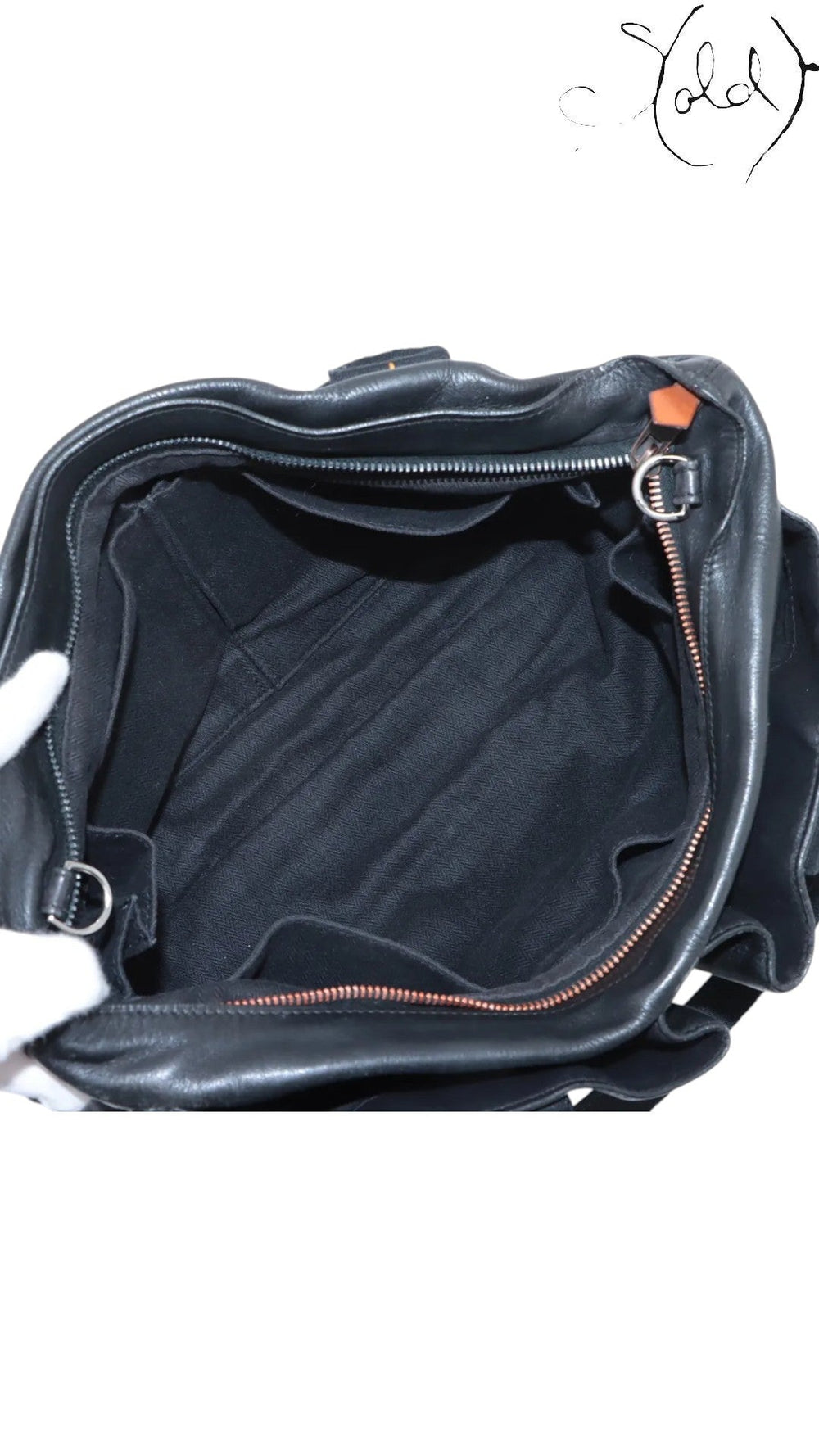 Sold Attire black Veau Derma leather Hermès Caravan Horizontal MM bag with silver hardware, showing interior pockets and herringbone lining.