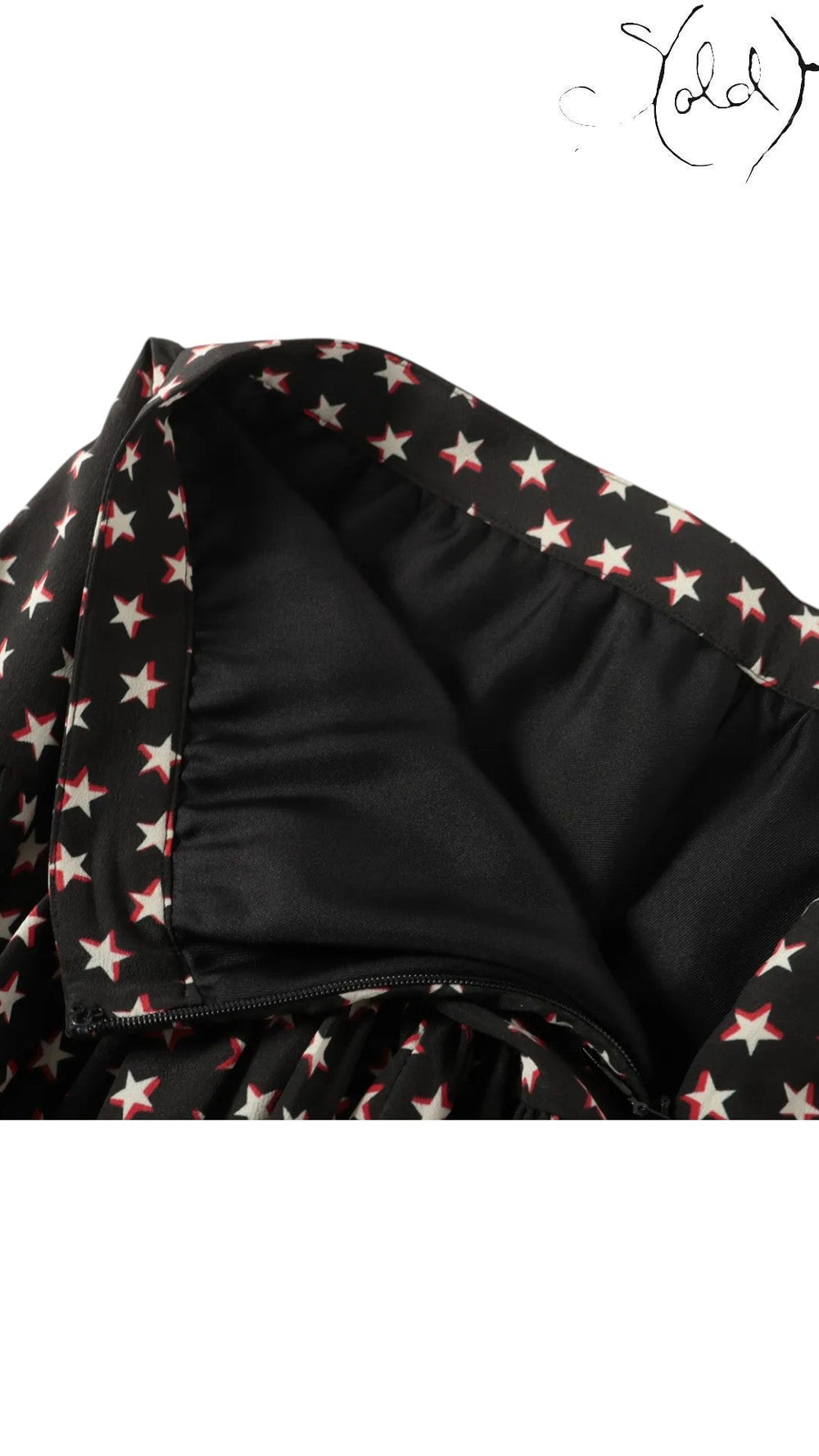 Sold Attire black silk twill mini skirt with a white and red star print, featuring a concealed back zipper and smooth black lining.