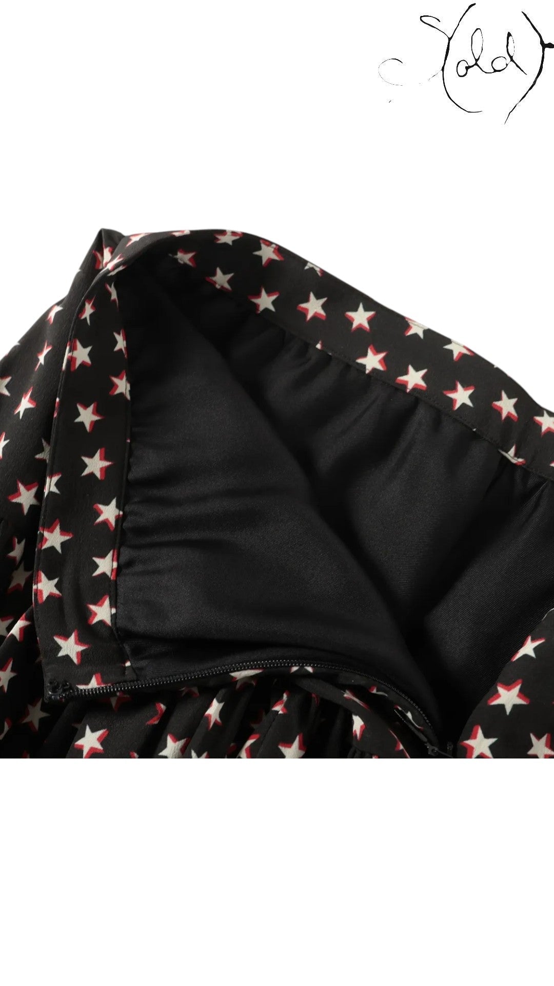 Sold Attire black silk twill mini skirt with a white and red star print, featuring a concealed back zipper and smooth black lining.