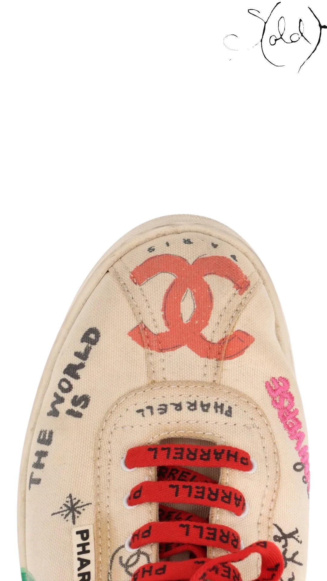 Sold Attire Chanel x Pharrell low-top canvas sneakers in white with multicolor graphic prints and red branded laces.