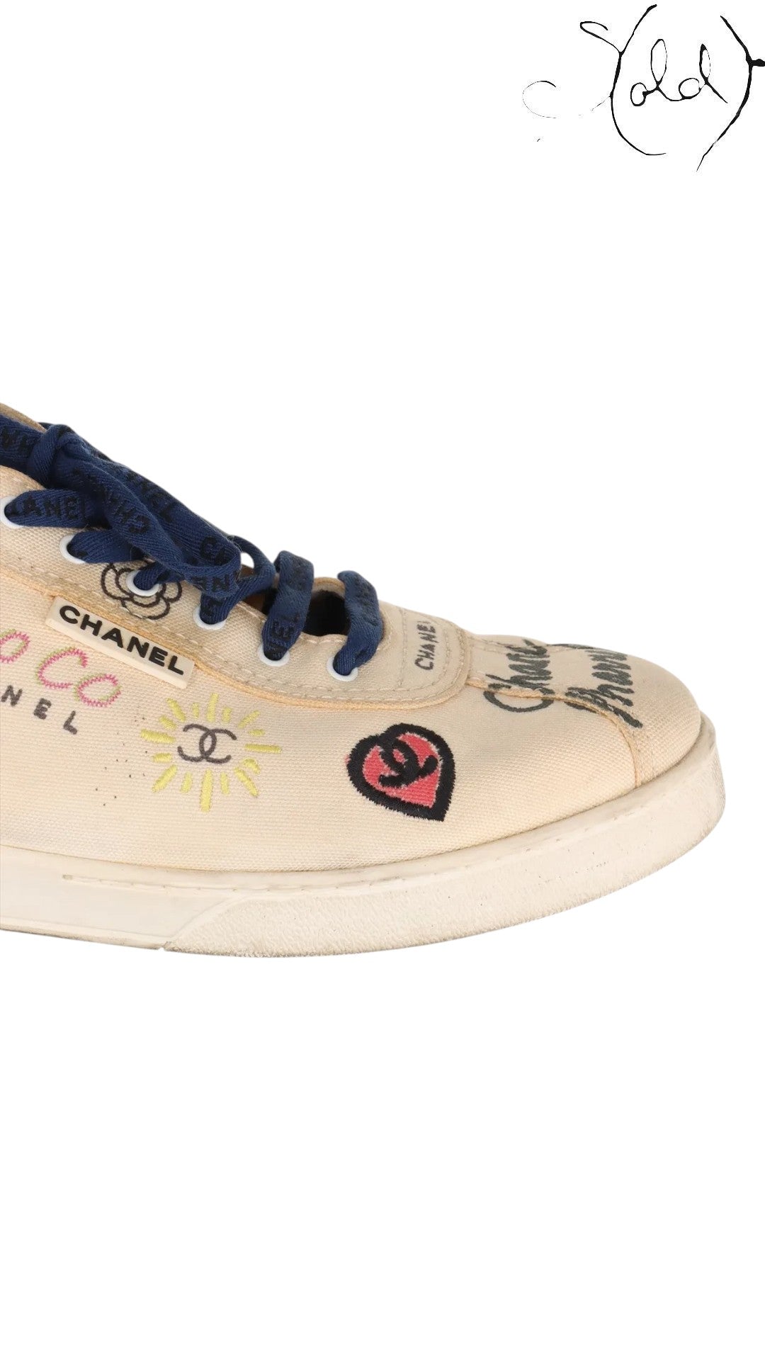 Sold Attire pre-owned Chanel x Pharrell low-top canvas sneakers in white with multicolor graphic prints and blue laces