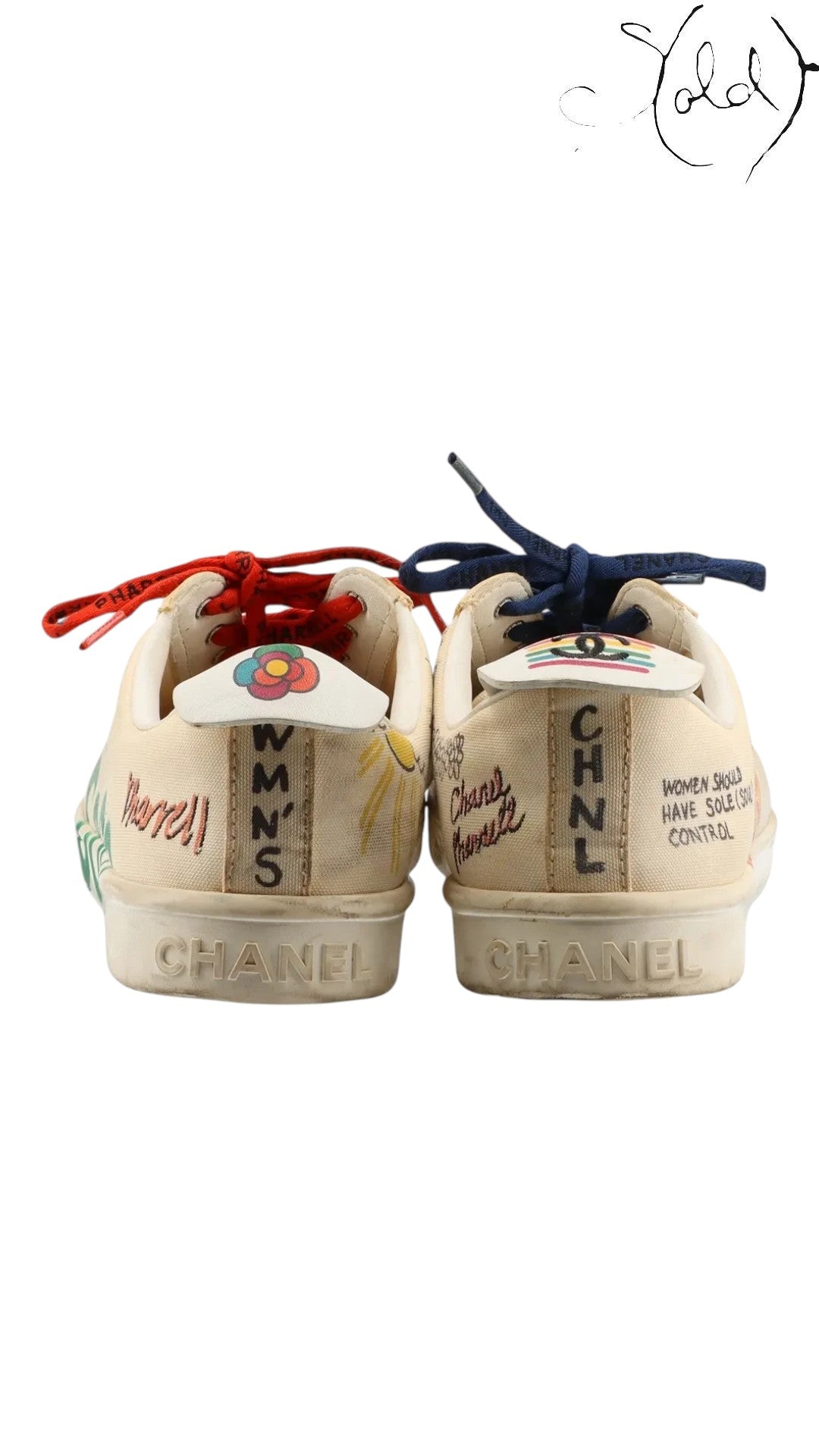 Sold Attire Chanel x Pharrell low-top sneakers in white canvas with multicolor graphic prints and mismatched laces.
