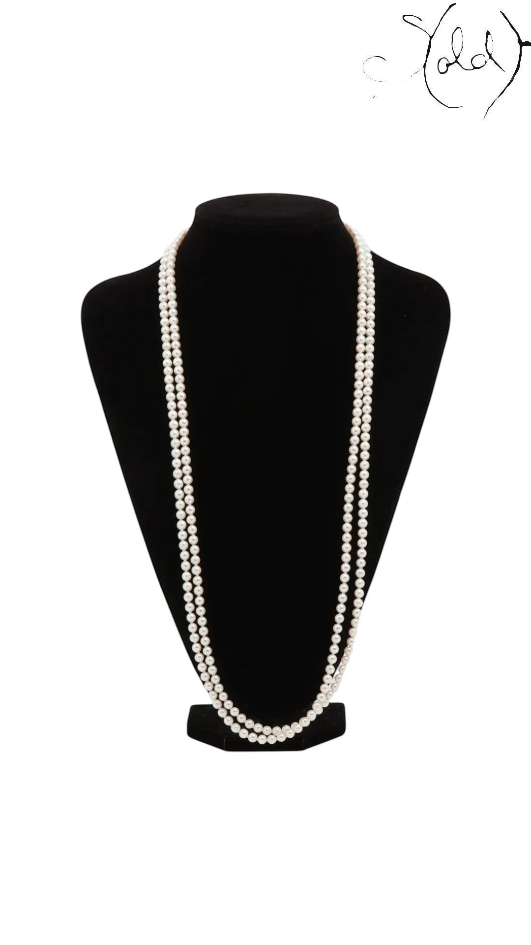 Sold Attire long Akoya pearl necklace in cream-white with a silver clasp, displayed on a black mannequin bust.