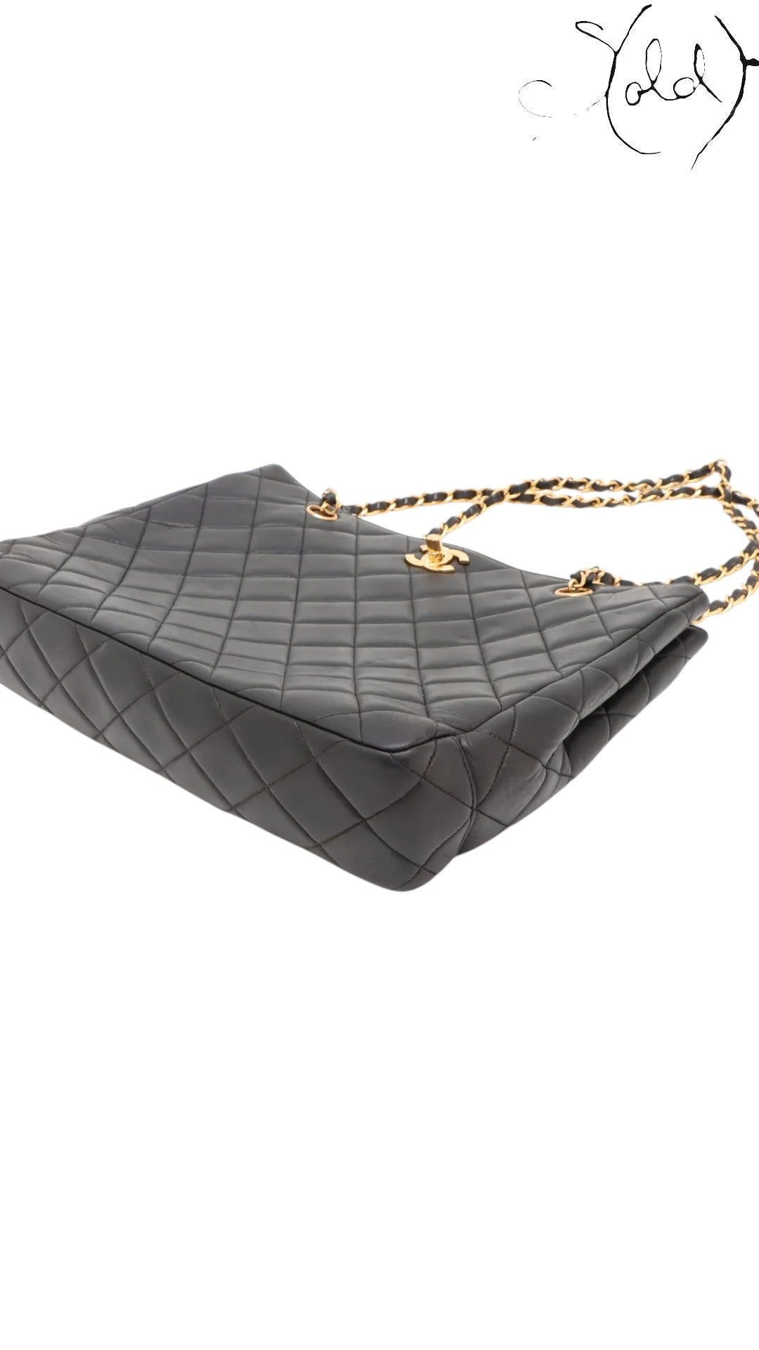 Sold Attire black quilted lambskin Chanel CC Turn-Lock chain tote with gold hardware and chain straps.