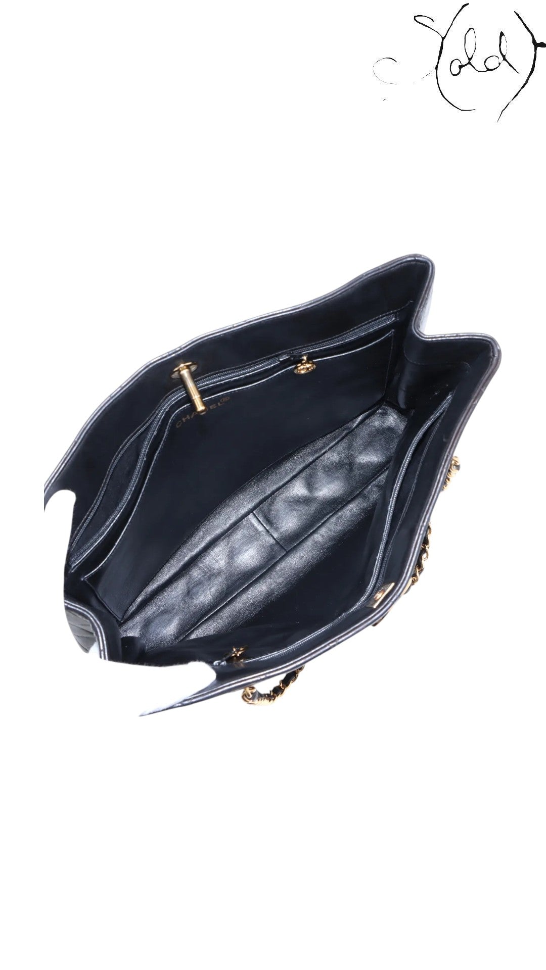 Sold Attire black quilted lambskin Chanel CC Turn-Lock chain tote with gold hardware and interior pockets.