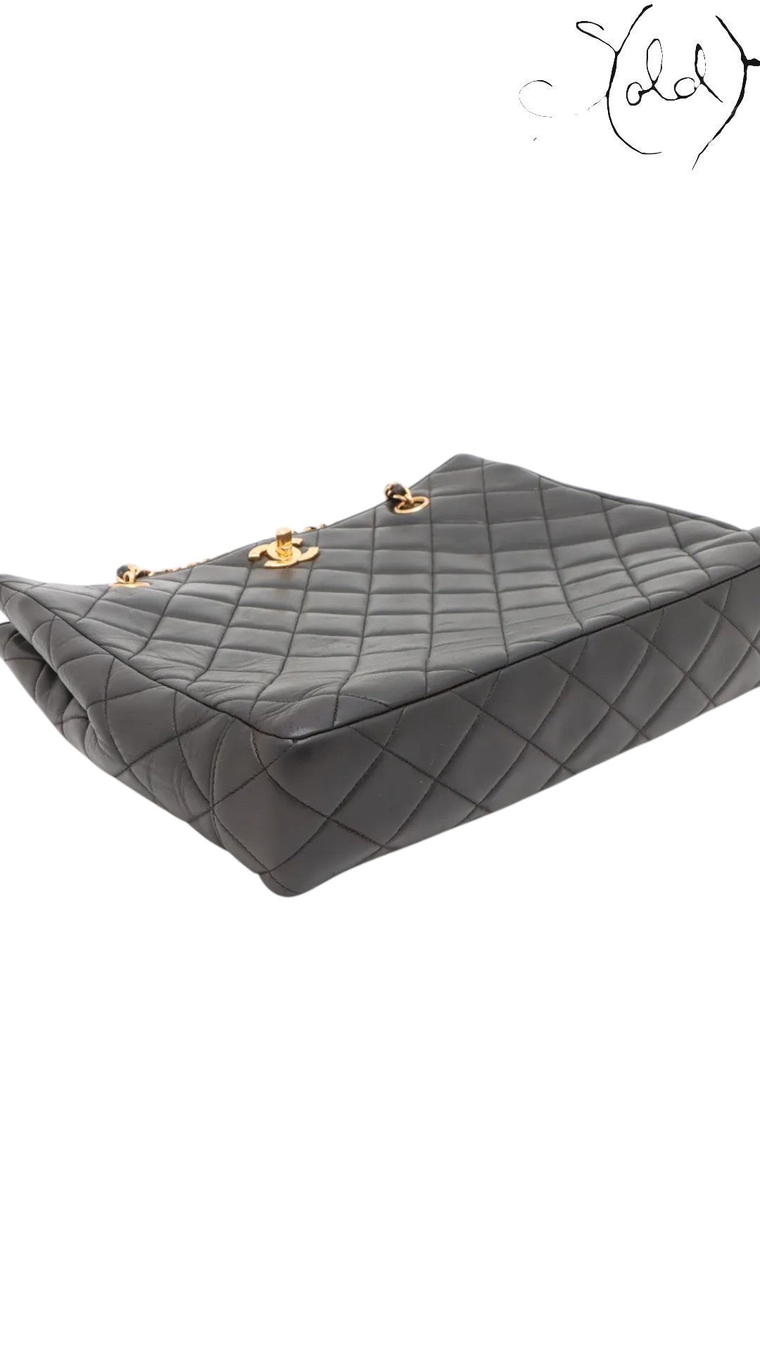 Sold Attire black quilted lambskin Chanel CC Turn-Lock chain tote with gold hardware.