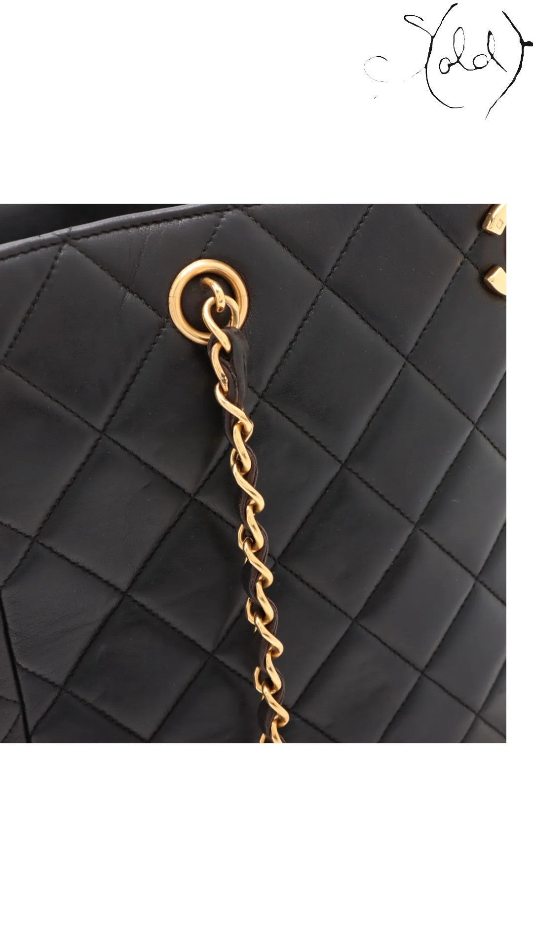 Sold Attire black quilted lambskin Chanel CC chain tote with gold-plated hardware and turn-lock closure.