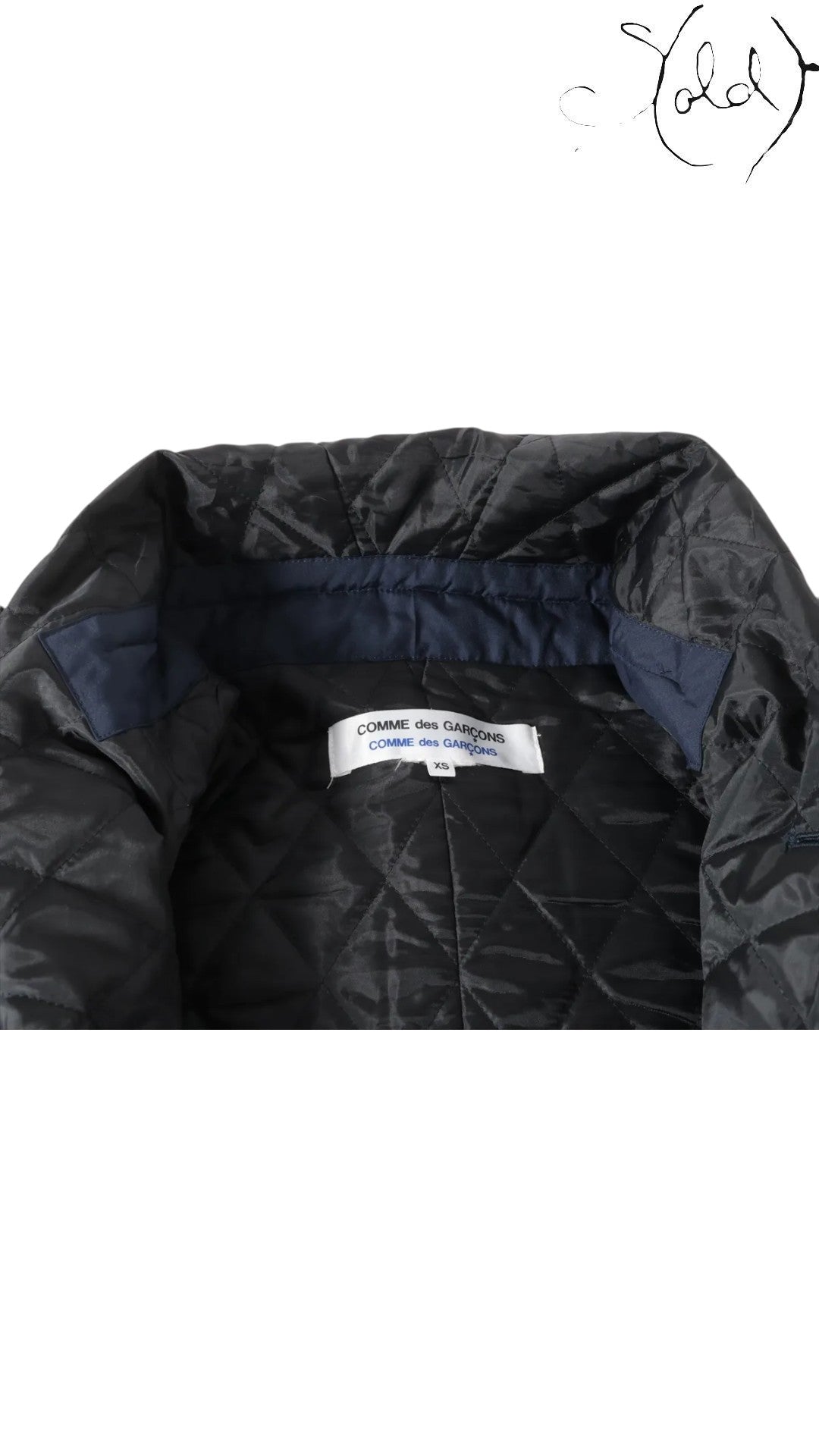 Sold Attire navy polyester padded cape coat with quilted lining and navy collar detail. Features Comme des Garçons label.