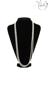 Sold Attire long Akoya pearl necklace in cream-white with a silver clasp, displayed on a black mannequin bust.