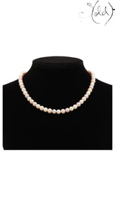 Sold Attire pink and peach Akoya pearl necklace with an SV925 silver clasp on a black display bust.
