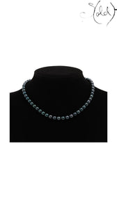 Sold Attire dark green-blue Akoya pearl necklace on a black display bust