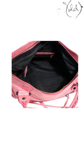 Sold Attire hot pink distressed lambskin Balenciaga The First 2-Way handbag with classic motorcycle studs and tassel zip pulls.