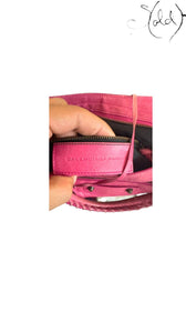 Sold Attire hot pink distressed lambskin Balenciaga The First 2-Way handbag with classic motorcycle studs and tassel zip pulls.
