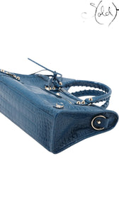 Sold Attire Balenciaga City bag in Bleu Marine crocodile-embossed calfskin with signature studs and rolled handles.