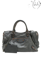 Sold Attire green distressed leather Balenciaga Giant City 2-Way Bag with aged metal hardware and front zip pocket.