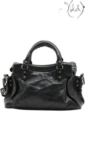 Sold Attire Balenciaga Neo Cagole XS handbag in black lambskin leather with silver-tone stud hardware and braided handles.