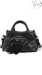Sold Attire Balenciaga Neo Cagole XS black lambskin handbag with silver stud hardware and heart-shaped mirror tag.