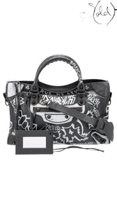 Sold Attire black agneau lambskin Balenciaga Graffiti City bag with white hand-painted graffiti and classic hardware.