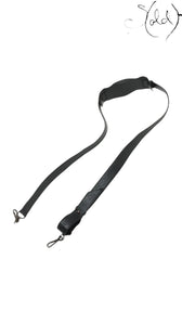 Sold Attire black agneau lambskin shoulder strap with aged brass hardware, adjustable length.