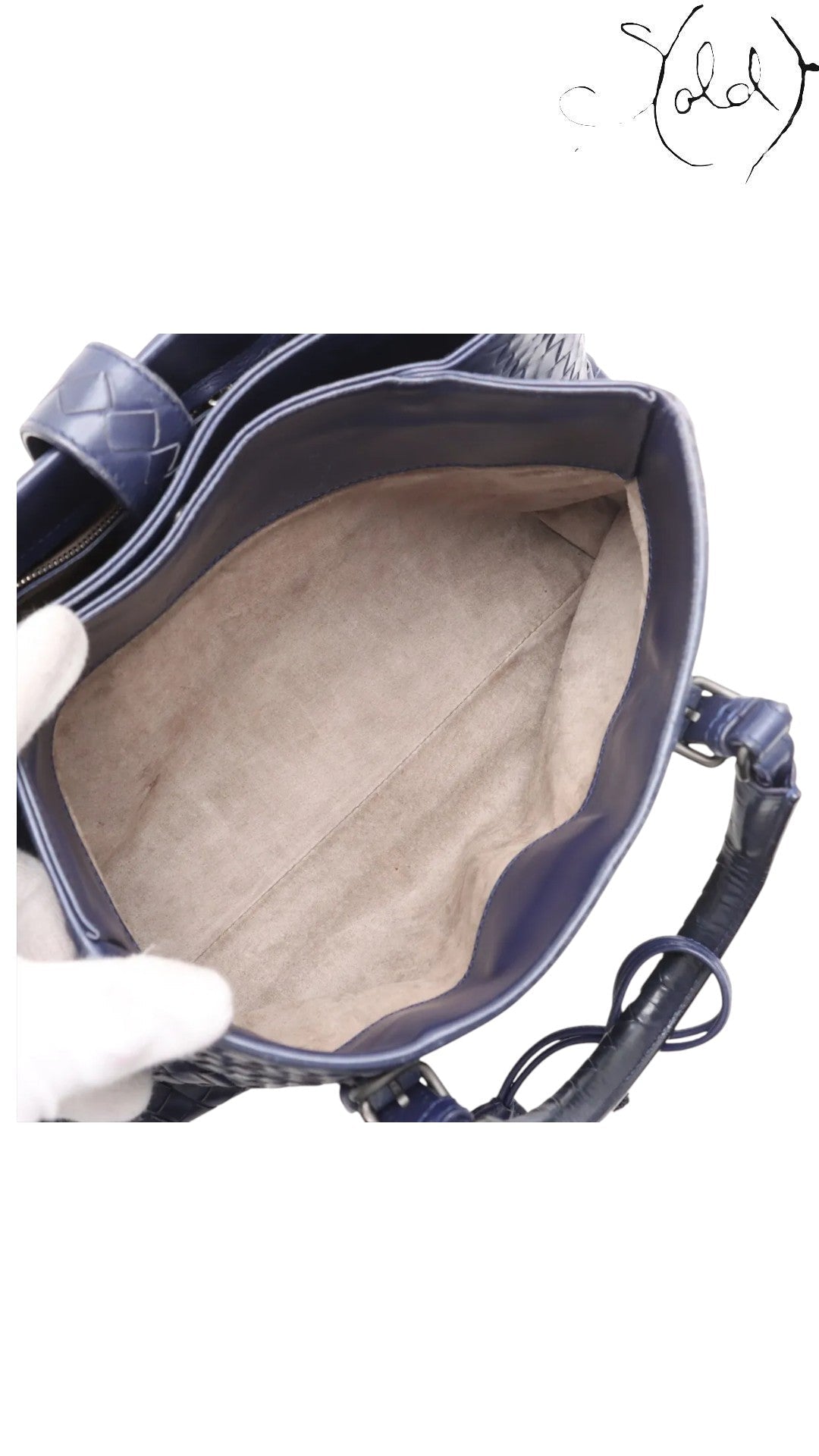 Sold Attire navy blue calfskin Bottega Veneta Roma small bag with signature Intrecciato weave and suede interior.