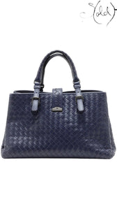 Sold Attire Bottega Veneta Roma Small navy blue calfskin intrecciato 2-way bag with twin top handles and a central buckle closure.