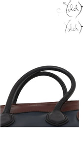 Sold Attire pre-owned Celine Luggage Mini Shopper in navy and brown leather with rolled handles and gold logo stamp