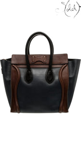 Sold Attire pre-owned Celine Luggage Mini Shopper in navy and brown leather with signature winged panels and rolled handles.