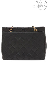 Sold Attire black quilted lambskin Chanel CC Turn-Lock chain tote with gold hardware and chain straps.