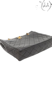 Sold Attire black quilted lambskin Chanel CC Turn-Lock chain tote with gold hardware.