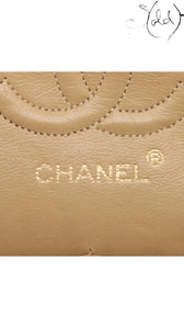 Sold Attire beige lambskin Chanel Matelasse 23 Double Flap bag detail showing quilted pattern and gold embossed logo.
