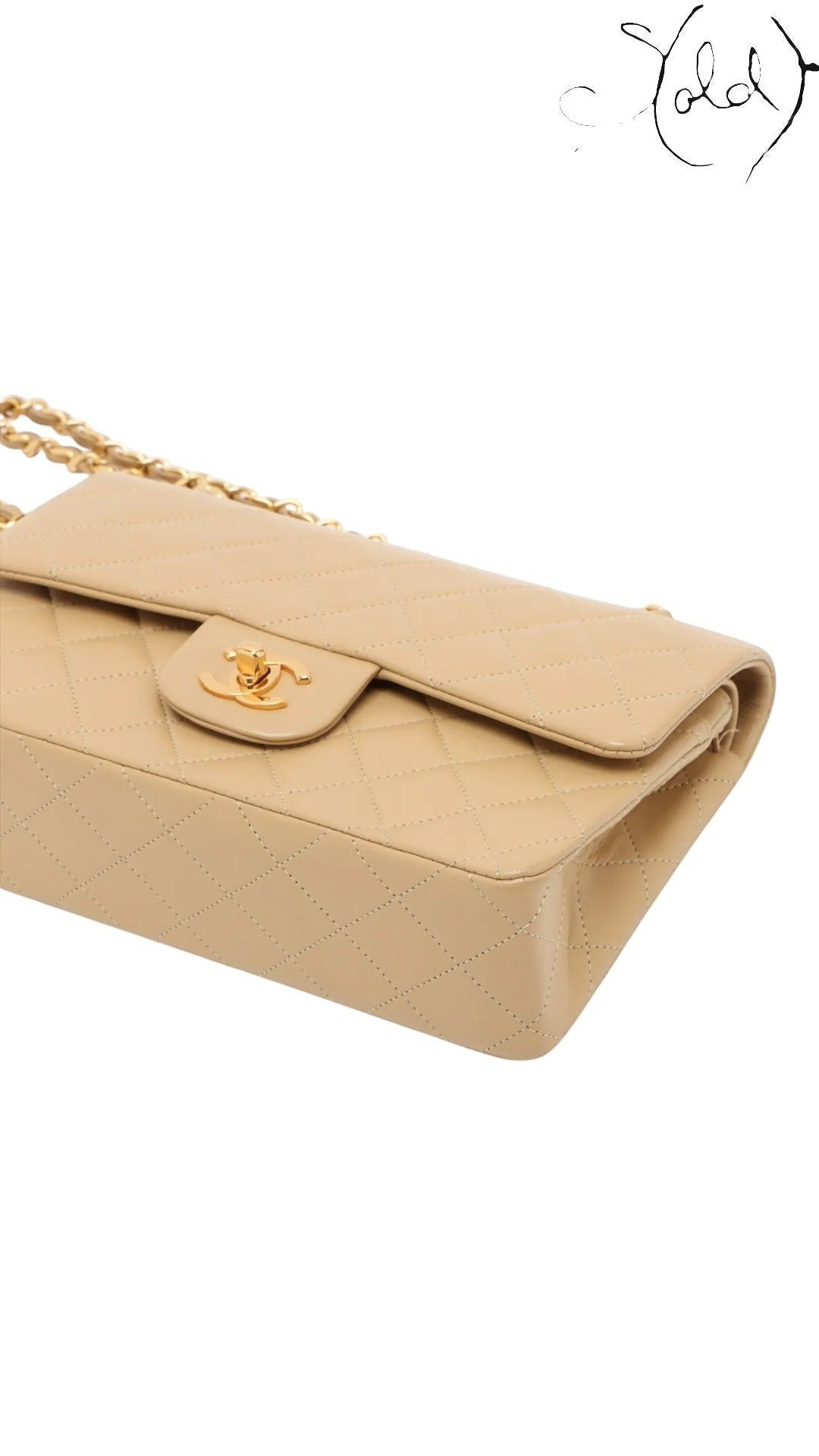 Sold Attire beige lambskin Chanel Matelasse 23 Double Flap bag with gold hardware and signature CC turn-lock closure.
