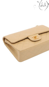 Sold Attire beige lambskin Chanel Matelasse 23 double flap bag with gold CC turn-lock closure and matelassé quilting.